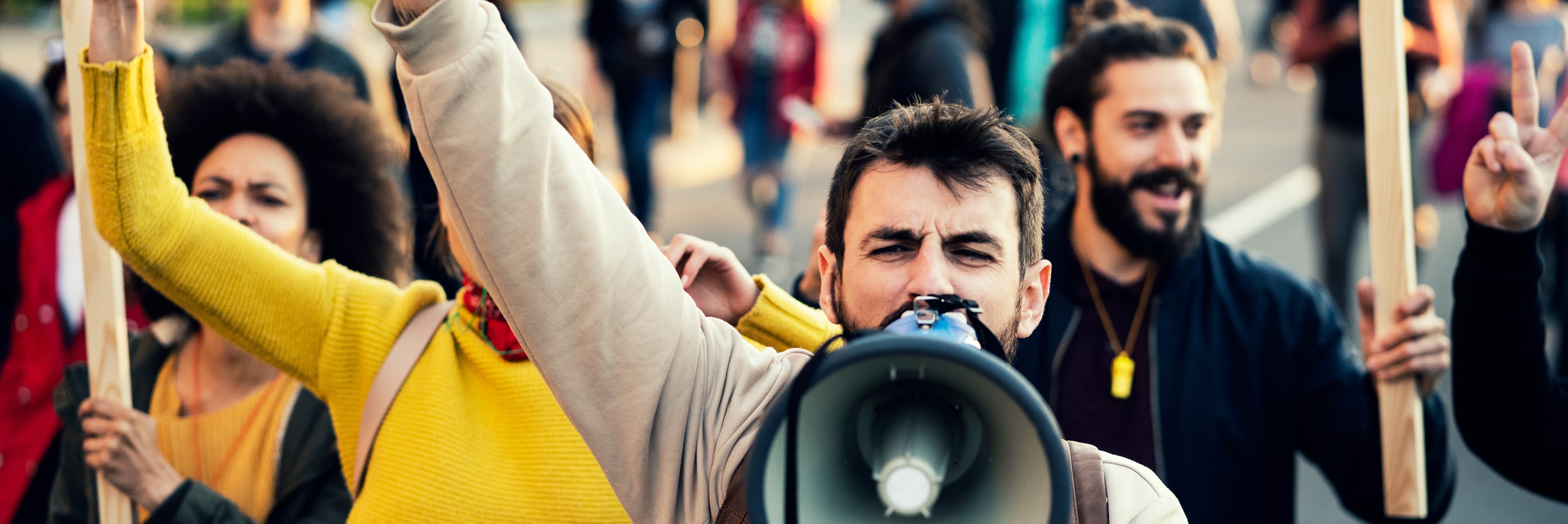 man speaking into megaphone 