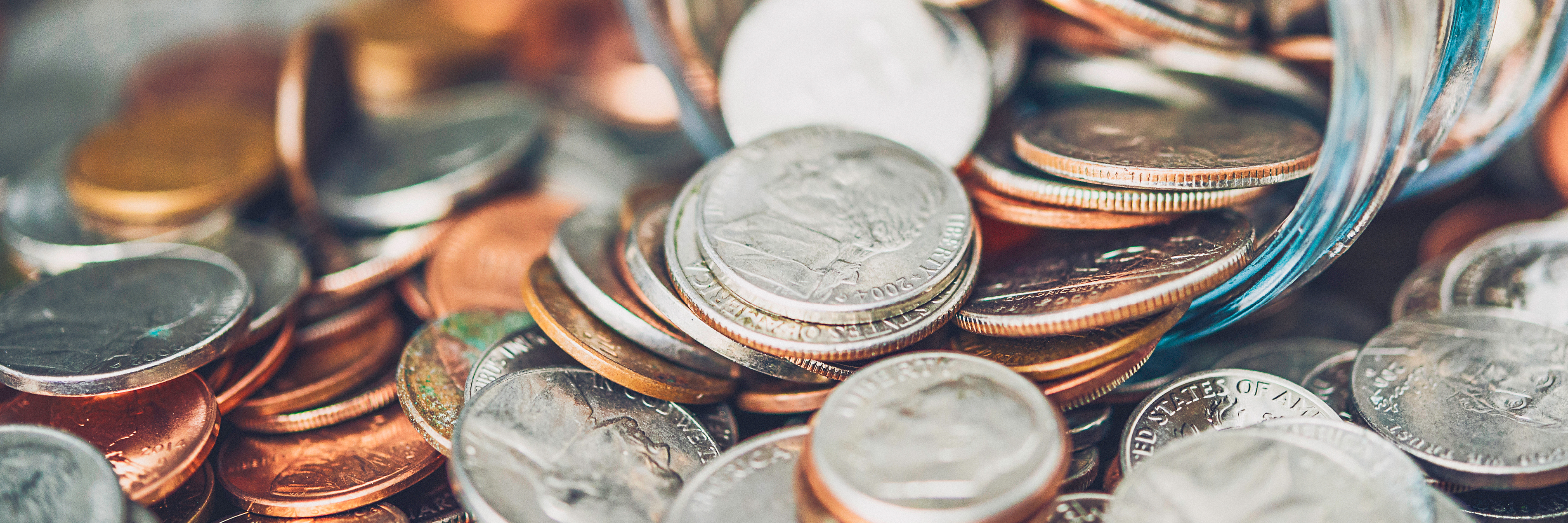 Coins spilling out of jar