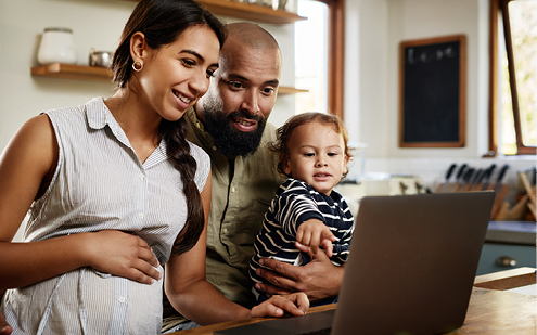 Mother, father and son looking at computer