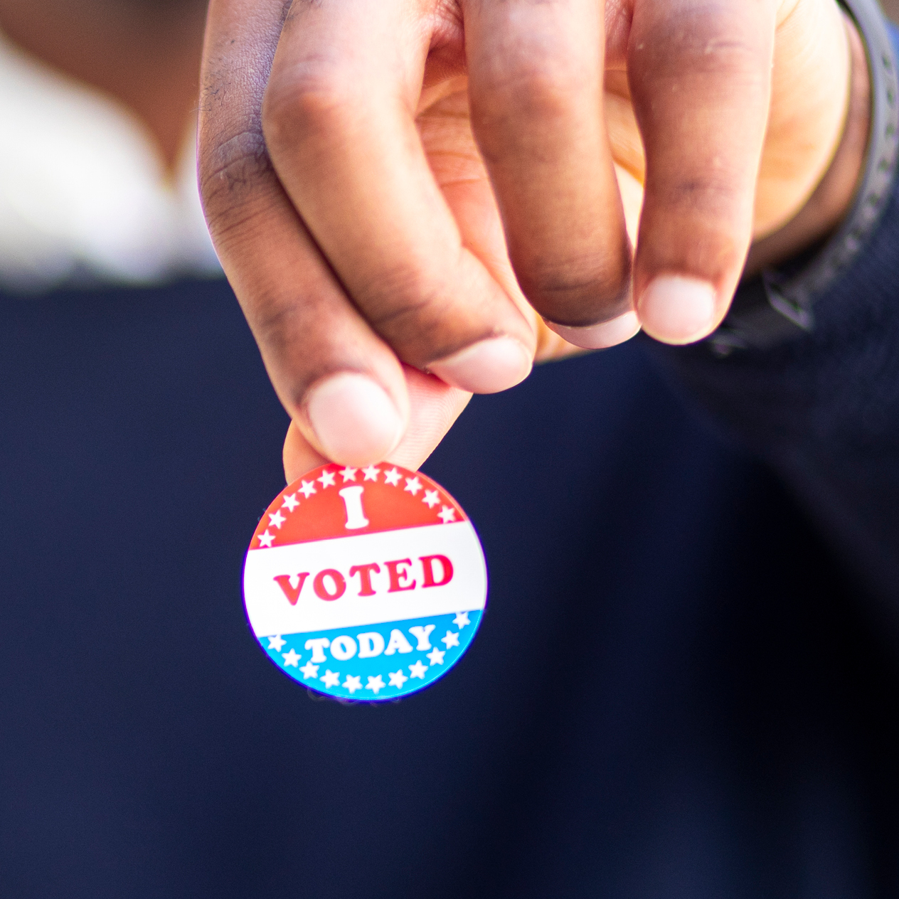 Man holding I voted today pin